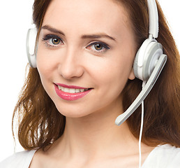 Image showing Lovely young woman is talking to customers