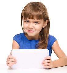 Image showing Young girl is using tablet