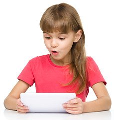 Image showing Young girl is using tablet