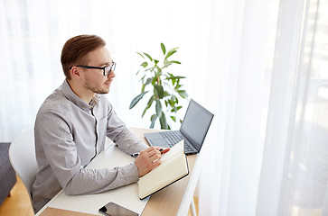 Image showing creative male worker or businessman with notebook