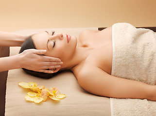 Image showing woman in spa salon lying on the massage desk