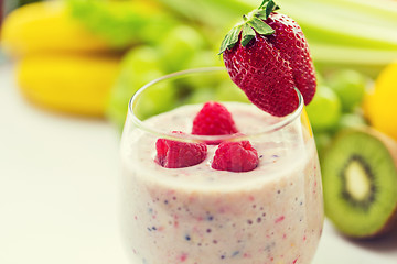 Image showing close up of glass with milk shake and fruits