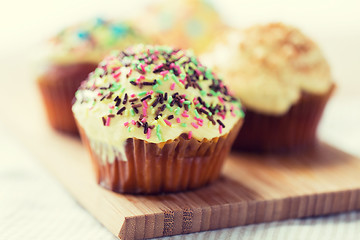 Image showing close up of glazed cupcakes or muffins on table