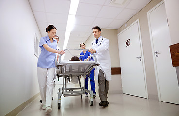 Image showing medics and patient on hospital gurney at emergency