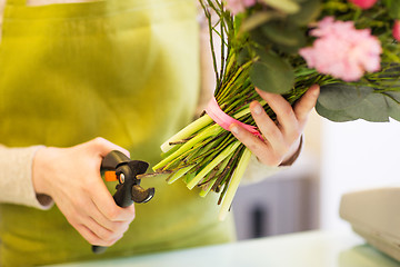 Image showing close up of florist woman with flowers and pruner