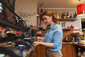 Image showing barista woman making coffee by machine at cafe