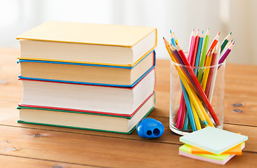 Image showing close up of crayons or color pencils and books