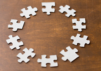 Image showing close up of puzzle pieces on wooden surface