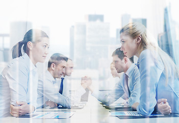 Image showing smiling business people having conflict in office