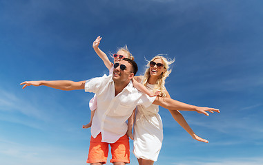 Image showing happy family having fun over blue sky background