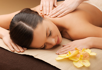 Image showing woman in spa salon lying on the massage desk