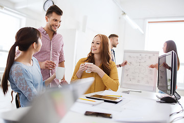 Image showing happy creative team drinking coffee at office