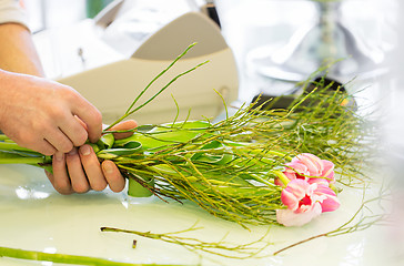 Image showing close up of man making bunch at flower shop