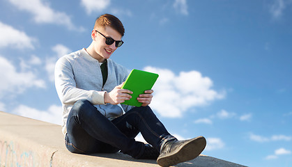 Image showing happy young man with tablet pc outdoors