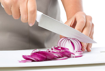 Image showing Cook is chopping onion