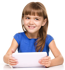 Image showing Young girl is using tablet