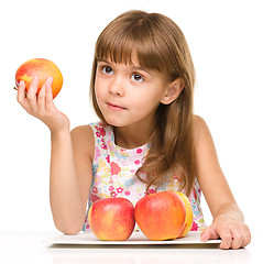 Image showing Little girl with red apples