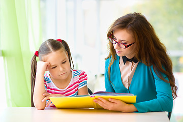 Image showing Mother is reading book with her daughter