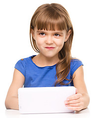 Image showing Young cheerful girl is using tablet