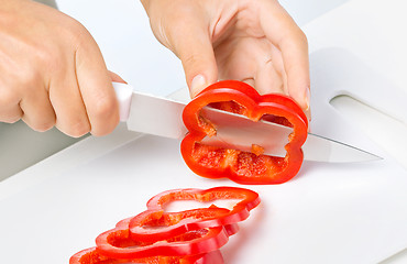 Image showing Cook is chopping bell pepper