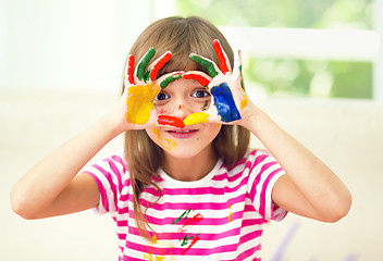 Image showing Portrait of a cute girl playing with paints