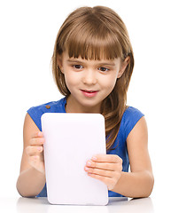 Image showing Young cheerful girl is using tablet