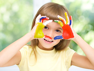 Image showing Portrait of a cute girl playing with paints