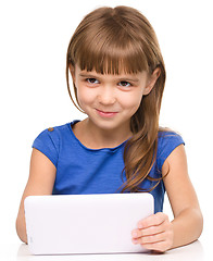 Image showing Young girl is using tablet