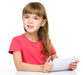 Image showing Young girl is using tablet