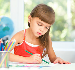 Image showing Little girl is drawing using pencils