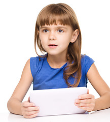 Image showing Young girl is using tablet