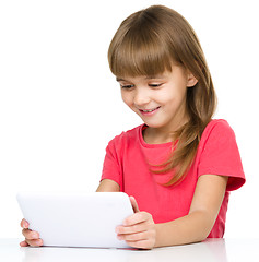 Image showing Young girl is using tablet