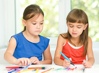 Image showing Little girls are drawing using pencils