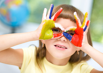 Image showing Portrait of a cute girl playing with paints