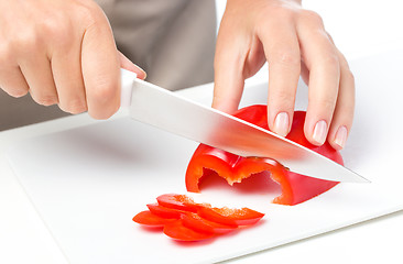 Image showing Cook is chopping bell pepper