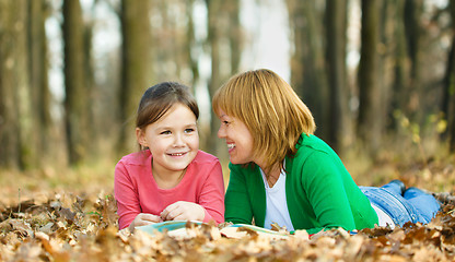 Image showing Mother is reading book with her daughter