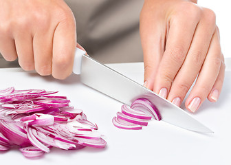 Image showing Cook is chopping onion