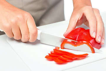 Image showing Cook is chopping bell pepper