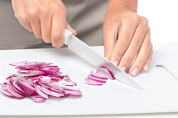 Image showing Cook is chopping onion