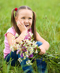 Image showing Portrait of a little girl with flowers