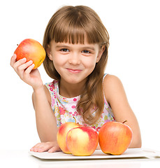 Image showing Little girl with red apples