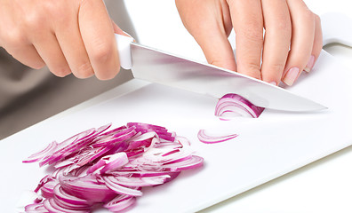 Image showing Cook is chopping onion