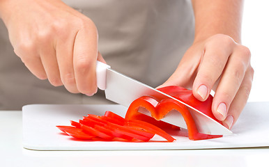 Image showing Cook is chopping bell pepper