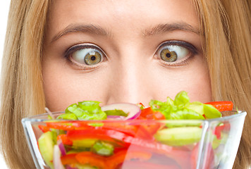 Image showing Woman is looking at salad