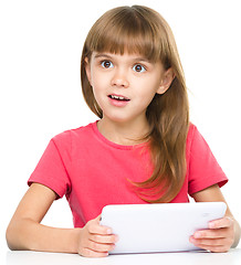Image showing Young girl is using tablet