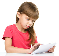 Image showing Young girl is using tablet