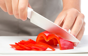 Image showing Cook is chopping bell pepper