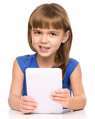 Image showing Young girl is using tablet