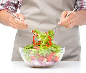 Image showing Cook is mixing salad
