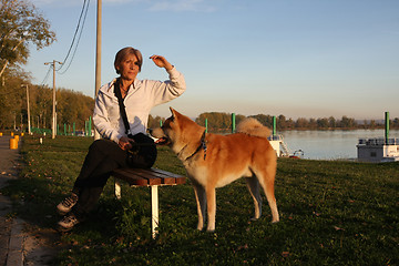 Image showing Lady sitting on the bench